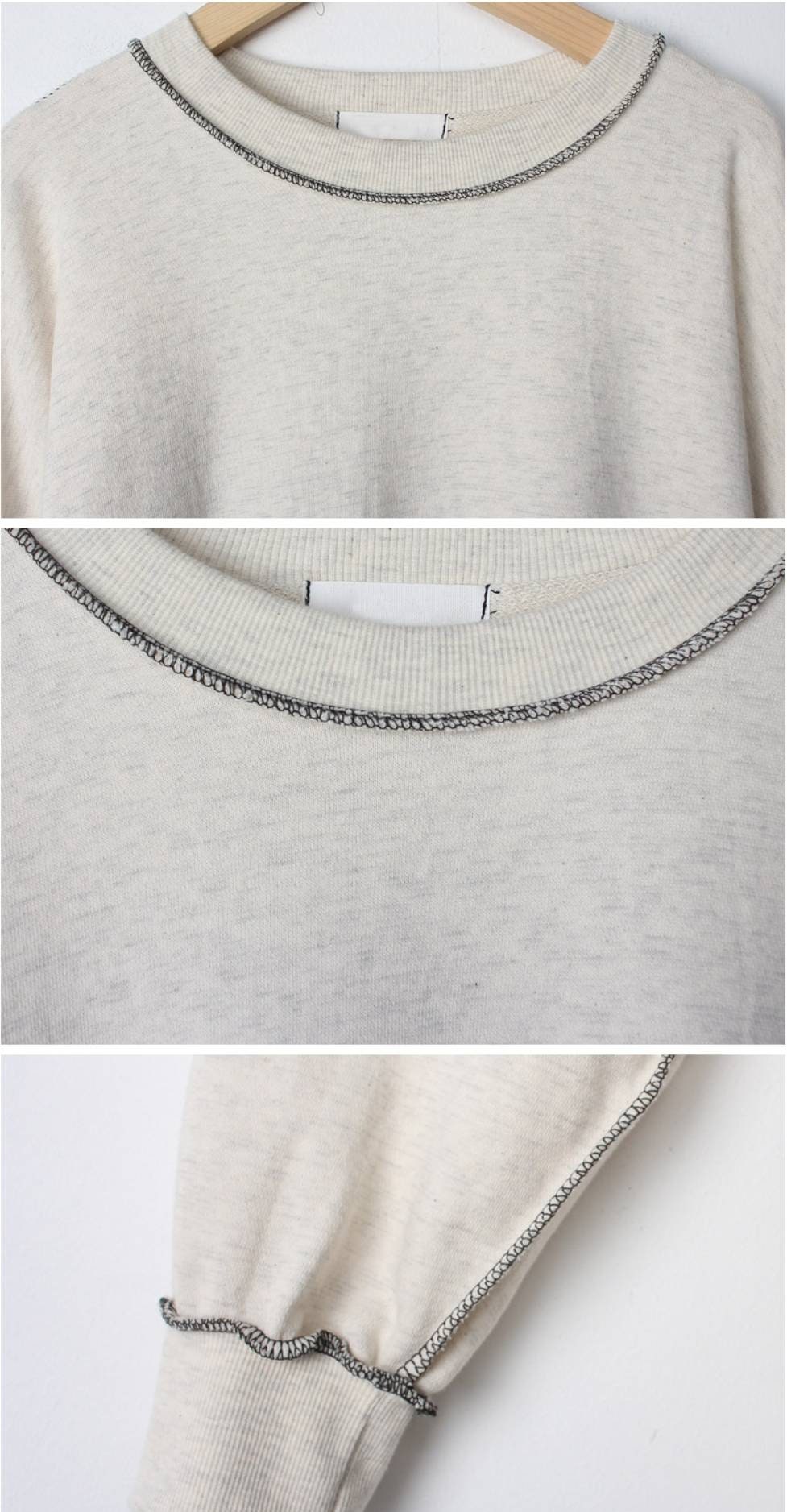 Close-up of the neckline stitching detail with contrast overlock seams on the sweater dress.